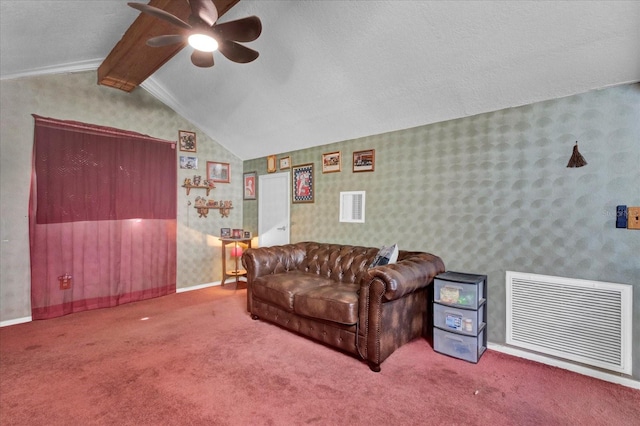 carpeted living area with lofted ceiling with beams, wallpapered walls, visible vents, and a ceiling fan