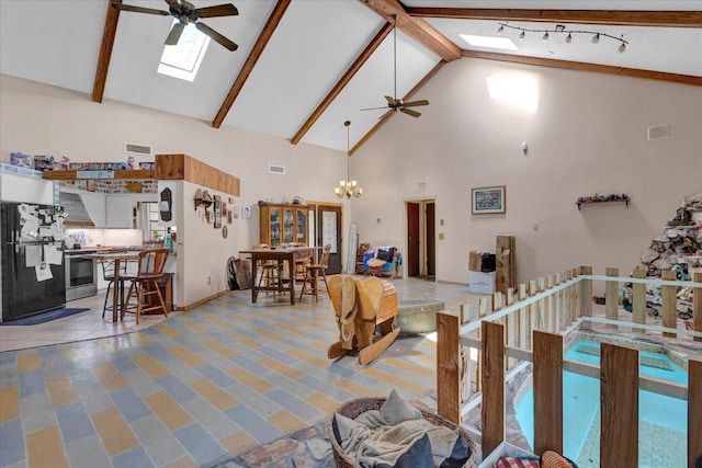 interior space featuring a skylight, visible vents, beamed ceiling, high vaulted ceiling, and ceiling fan with notable chandelier