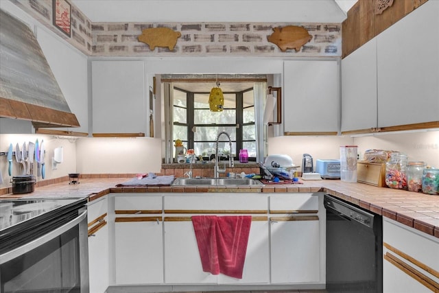 kitchen with tile counters, white cabinets, dishwasher, wall chimney exhaust hood, and a sink