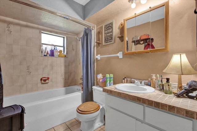 bathroom with toilet, tile patterned flooring, shower / bathtub combination with curtain, and vanity