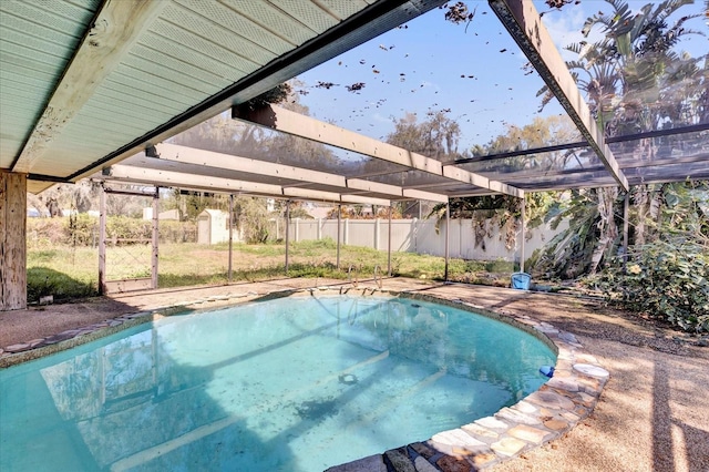 view of pool featuring a lanai and fence