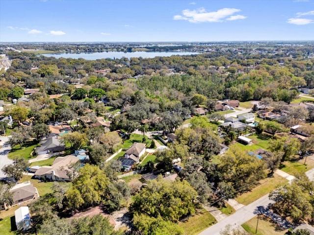 birds eye view of property with a water view and a forest view