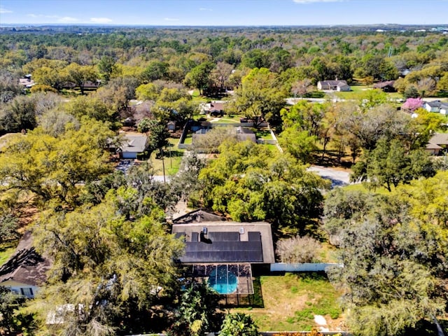 birds eye view of property featuring a wooded view