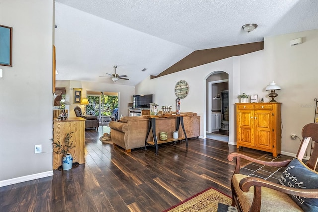 living room with arched walkways, lofted ceiling, ceiling fan, wood finished floors, and baseboards