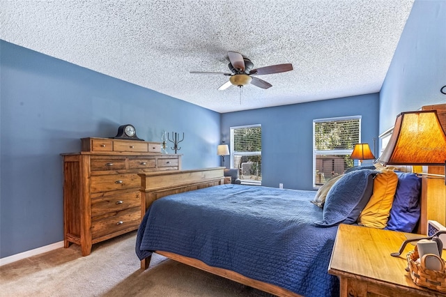 bedroom featuring carpet, ceiling fan, a textured ceiling, and baseboards