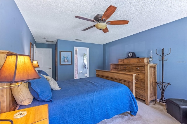 bedroom featuring visible vents, a ceiling fan, connected bathroom, a textured ceiling, and carpet flooring