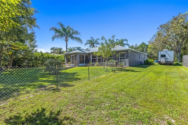 view of yard featuring a sunroom and fence