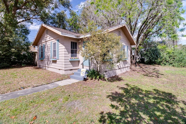 view of front of home with crawl space and a front yard