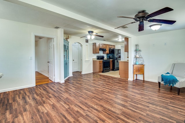 unfurnished living room featuring ceiling fan, wood finished floors, visible vents, and baseboards