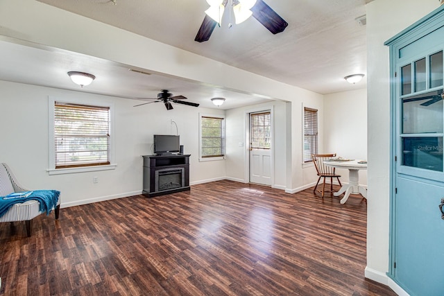 sitting room with plenty of natural light, baseboards, and wood finished floors