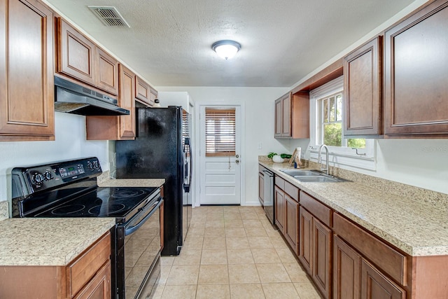 kitchen featuring light countertops, visible vents, a sink, under cabinet range hood, and black appliances