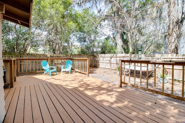 wooden terrace featuring a fenced backyard