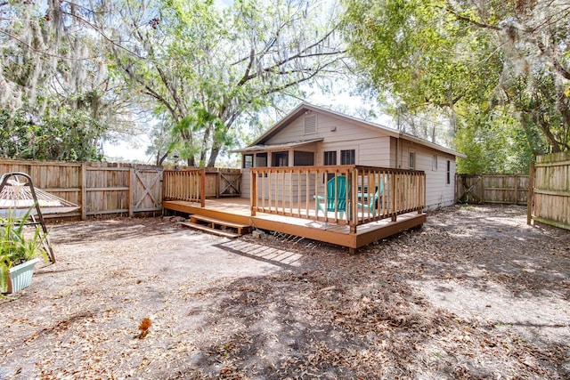 back of property featuring a fenced backyard and a deck