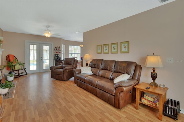 living area featuring french doors and light wood-style flooring