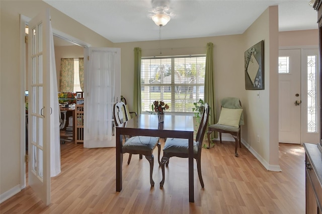 dining area featuring baseboards, plenty of natural light, and light wood-style floors