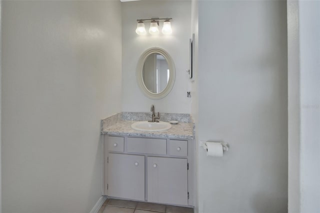 bathroom featuring vanity, baseboards, and tile patterned floors