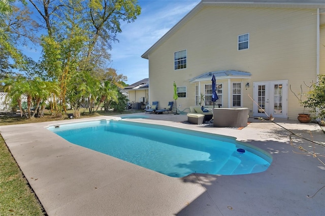 outdoor pool featuring french doors and a patio area