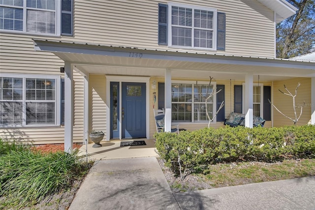 view of exterior entry with covered porch