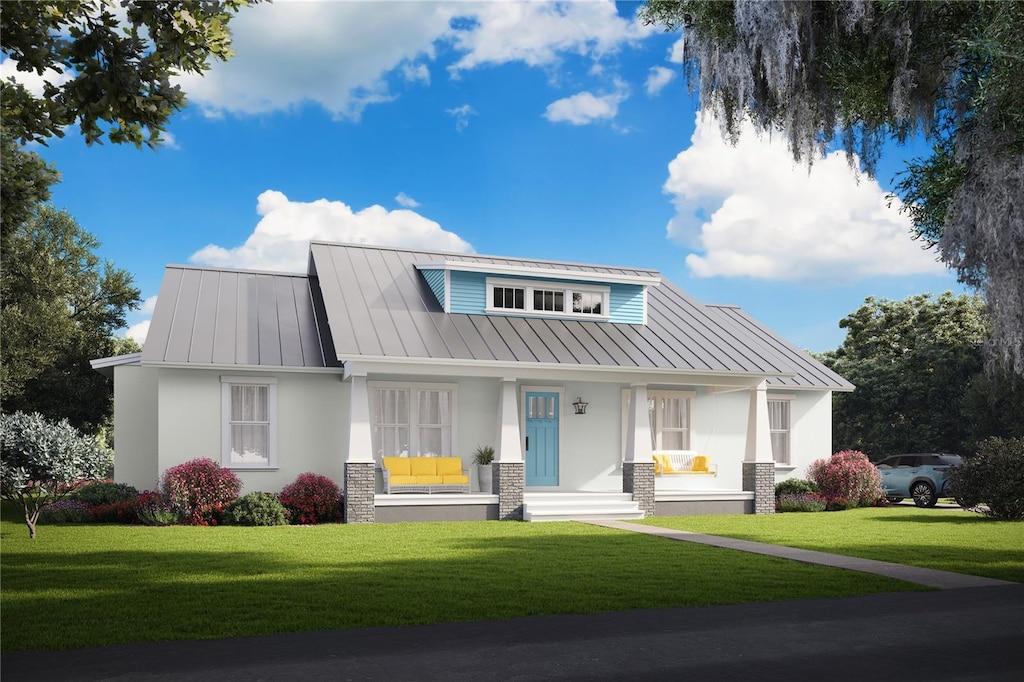 view of front of house with metal roof, a standing seam roof, and stucco siding