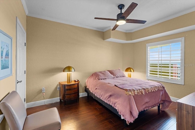 bedroom with a ceiling fan, wood-type flooring, crown molding, and baseboards