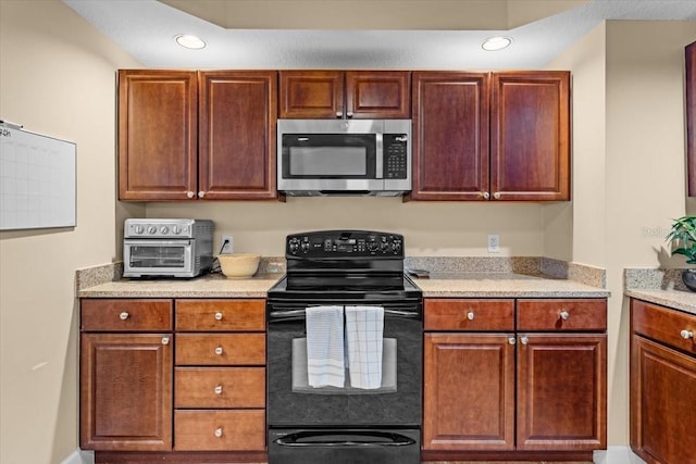 kitchen featuring a toaster, stainless steel microwave, recessed lighting, and black electric range oven