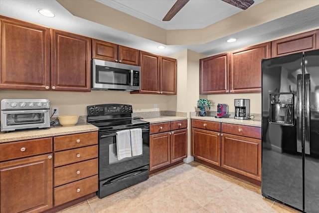 kitchen with light tile patterned floors, a toaster, crown molding, black appliances, and recessed lighting