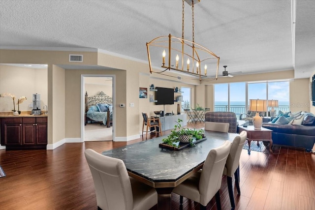 dining room with a textured ceiling, dark wood-style flooring, visible vents, baseboards, and an inviting chandelier