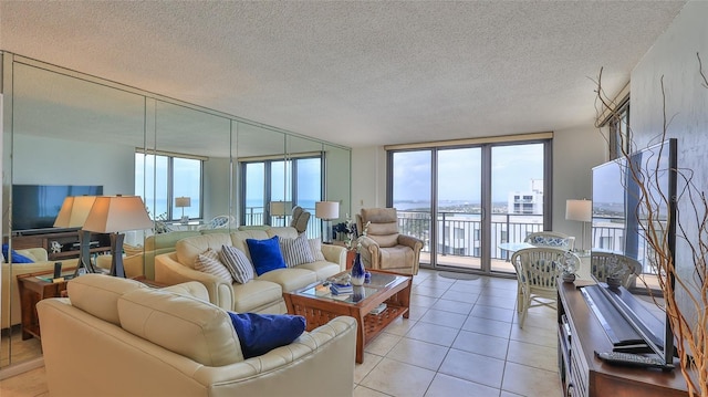 3051 S Atlantic Ave Unit 2206, Daytona Beach, FL 32118 - living area with a wall of windows, a textured ceiling, a wealth of natural light, and light tile patterned floors