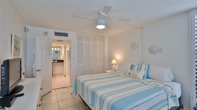 3051 S Atlantic Ave Unit 2206, Daytona Beach, FL 32118 - bedroom with visible vents, a textured ceiling, a closet, and light tile patterned floors
