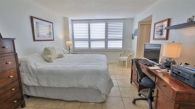 3051 S Atlantic Ave Unit 2206, Daytona Beach, FL 32118 - bedroom with light tile patterned flooring, a textured ceiling, and a closet