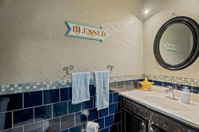 bathroom with vanity and a textured wall