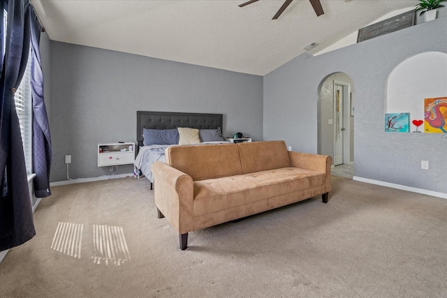 carpeted bedroom with visible vents, heating unit, arched walkways, ceiling fan, and vaulted ceiling