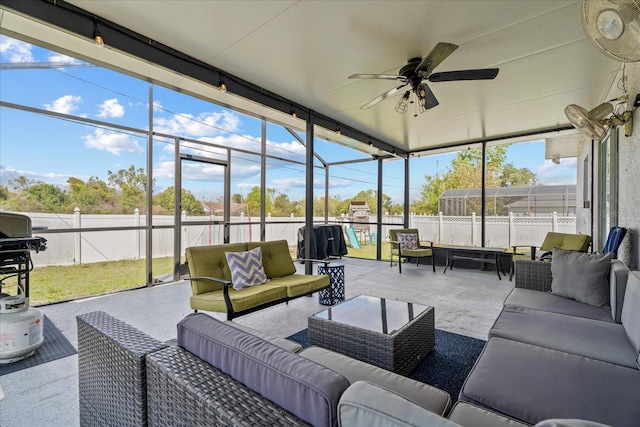 sunroom / solarium featuring ceiling fan