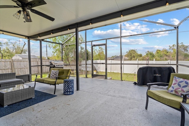 sunroom featuring a healthy amount of sunlight and ceiling fan