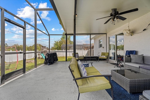 sunroom featuring ceiling fan