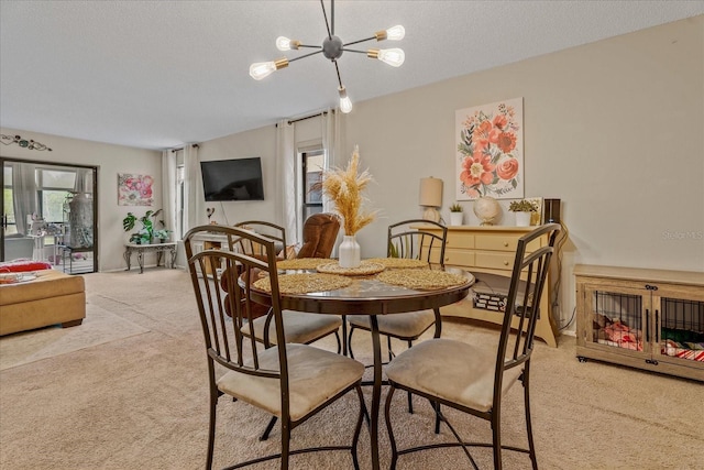 dining room with a textured ceiling, an inviting chandelier, and carpet floors