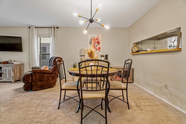 dining room featuring a notable chandelier, baseboards, carpet floors, and a textured ceiling