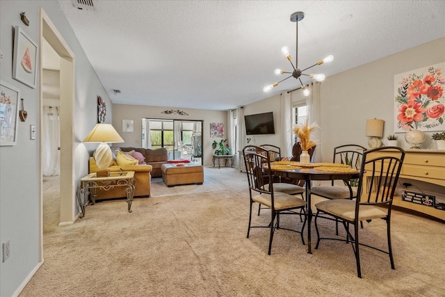 dining room featuring a textured ceiling, an inviting chandelier, baseboards, and light carpet