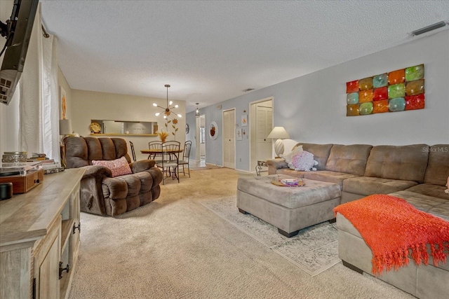 living room with light carpet, visible vents, a textured ceiling, and a notable chandelier