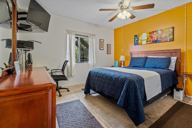 bedroom with a ceiling fan, carpet, baseboards, and a textured ceiling