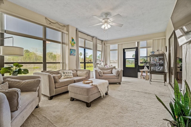 sunroom / solarium featuring ceiling fan