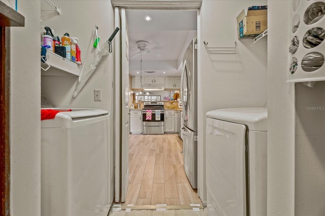 laundry room with washer and dryer, laundry area, light wood-type flooring, and ceiling fan