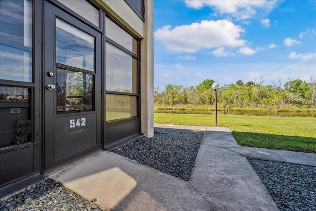 doorway to property featuring a yard