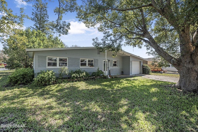 ranch-style home featuring an attached garage, a front lawn, concrete driveway, and brick siding