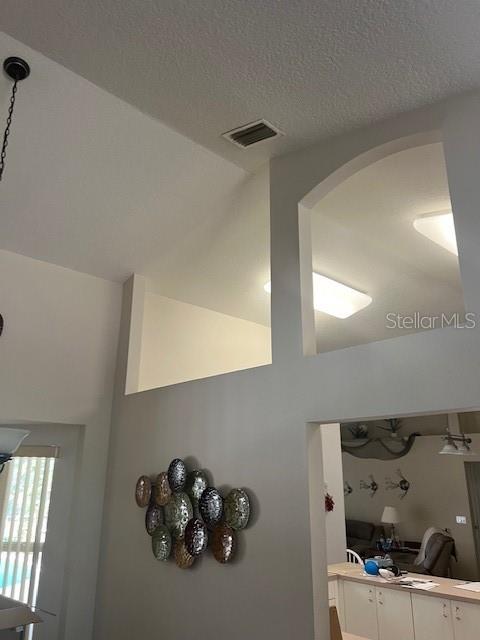 room details featuring visible vents and a textured ceiling