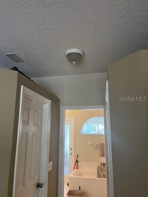 bathroom with visible vents and a textured ceiling