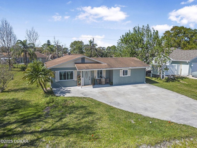 ranch-style home with a front yard, fence, and stucco siding