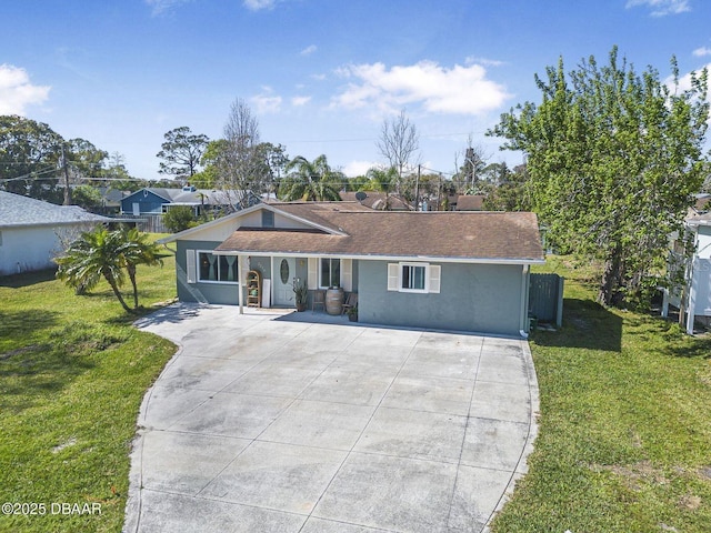 ranch-style house featuring roof with shingles, a front lawn, and stucco siding