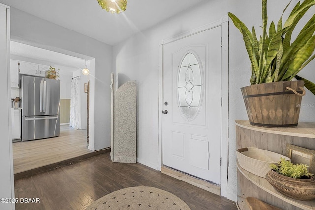 foyer featuring wood finished floors and baseboards