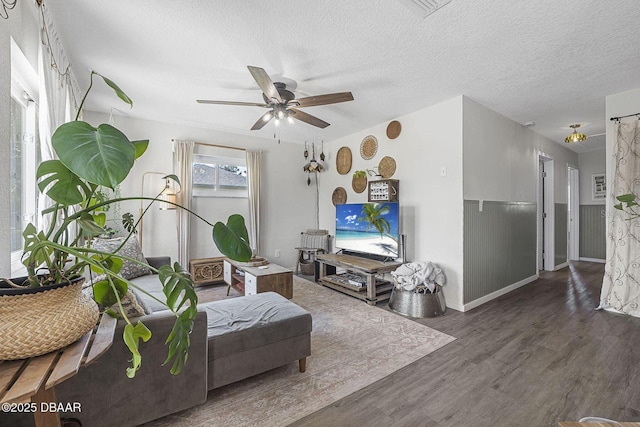 interior space featuring a textured ceiling, wood finished floors, and a ceiling fan